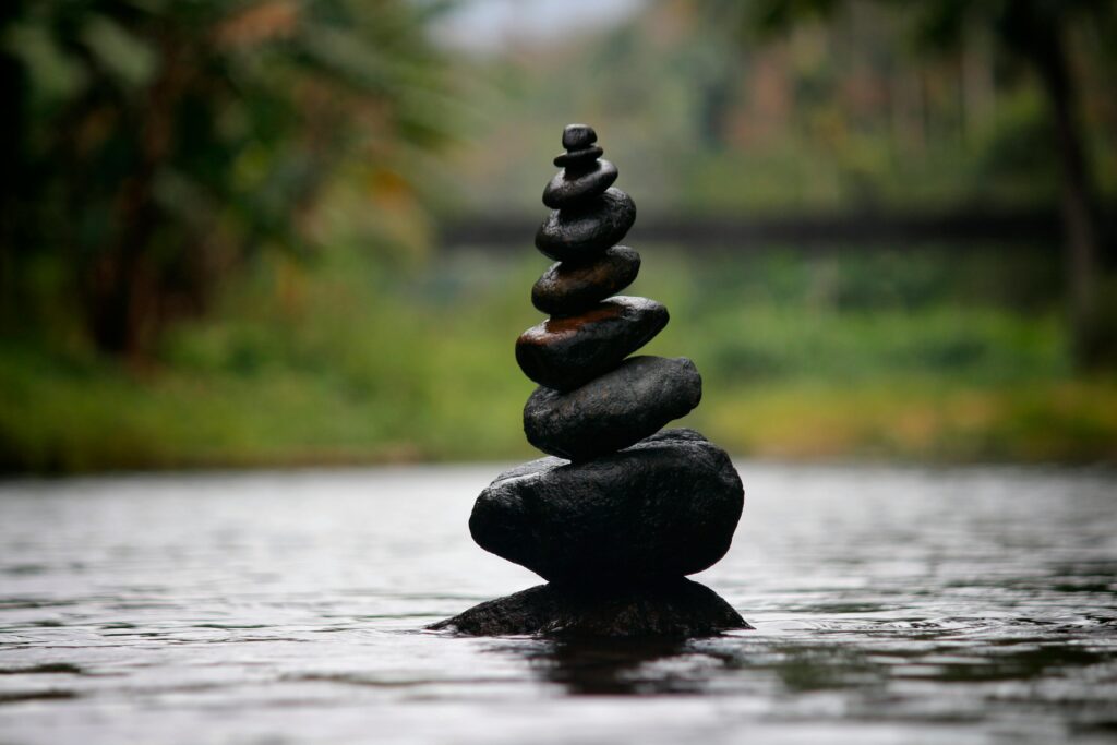 pexels-photo-312839-312839 Balanced stones in a serene river evoke a sense of peace and tranquility.